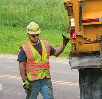 Worker behind truck